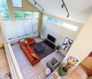inviting living room with a wall of windows w direct lake view