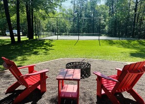 Fire pit facing the yard and tennis court