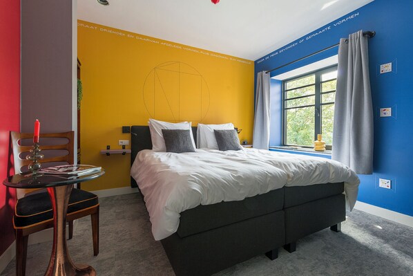 Vibrant and cozy bedroom featuring bold colors and stylish decor.
Stay central and save money at Hotel Tilburg! Ideal for Efteling adventures, Beekse Bergen trips, or exploring Tilburg itself.