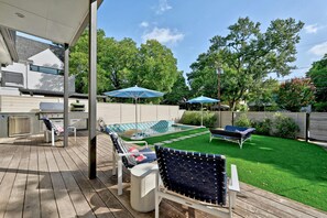 Large ipe deck with outdoor kitchen and pool