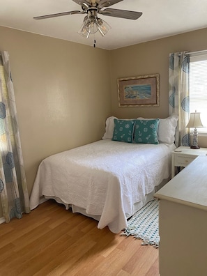 Aqua bdrm with full size bed, dresser and closet.