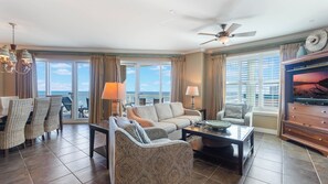 View from kitchen to 4-seat breakfast bar, living room and private balcony.