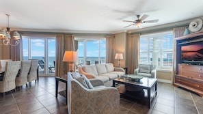 View from kitchen to 4-seat breakfast bar, living room and private balcony.