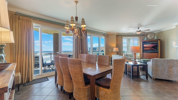 Dining area with 8-seats and living room space with 2-door access to balcony.