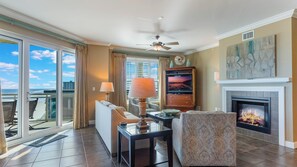 View from kitchen to 4-seat breakfast bar, living room and private balcony.