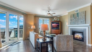 View from kitchen to 4-seat breakfast bar, living room and private balcony.