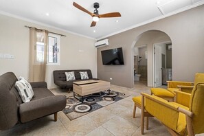 Enjoy the spacious living area, designed with modern, comfortable furniture for ultimate relaxation. Whether you're unwinding after a day at the beach or gathering with loved ones, this inviting space offers both style and comfort.