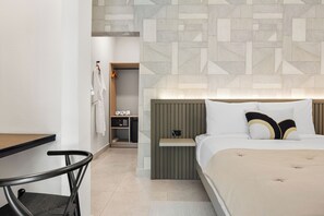 This well-lit bedroom offers a dedicated workspace with a desk and chair, perfect for catching up on emails or remote work.