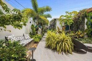 Unwind and recharge in our enchanting outdoor space. Take a dip in the pool, surrounded by lush greenery and playful signage, or challenge yourself in our well-equipped alfresco gym.