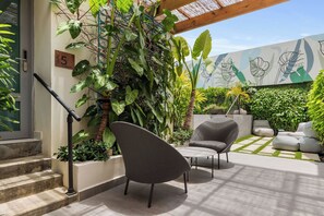 Immerse yourself in a world of charm and whimsy. Our vibrant exterior welcomes you with a sparkling pool, open-air gym, and delightful signage at every turn.