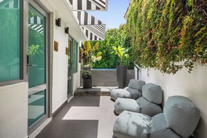 Step outside and embrace the vibrant energy of our boutique hotel. The sparkling pool, outdoor gym, and charming signage create a captivating atmosphere that invites you to explore and play
