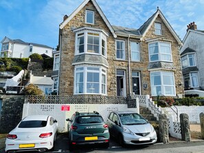Henry's is the Ground floor flat, with parking space where white car is parked
