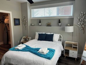 Bedroom Retreat: Bright space with stylish decor, plush bedding, and fresh greenery awaits you!