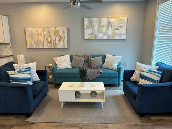 Living Room: Bright space with stylish seating, vibrant decor, and artistic touches for relaxation!