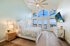 Bedroom #1 with king bed, vaulted ceilings and a wall of windows