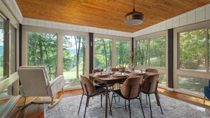 Sunroom with floor-to-ceiling windows overlooking the golf course and ski slopes