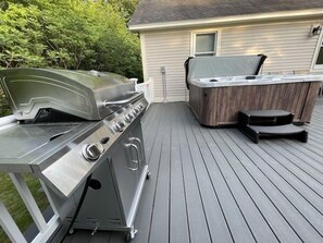 Deack with hot tub and grill// Grill is plugged into propane of home. Never run 