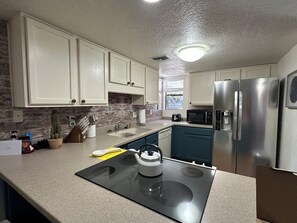 Great kitchen open to living and dining and bar seating to chat while cooking 