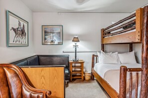 Bedroom 1: Twin-over-queen bunk bed, closet, dresser, leather couch, 40” TV, main floor