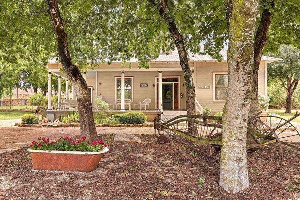 Experience the timeless beauty of The Country House, complete with a wraparound porch ideal for leisurely afternoons.