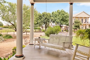 Experience ultimate relaxation on the inviting patio swing, nestled in the tranquil setting of The Country House.
