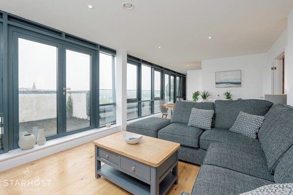 Spacious living room with lounge, kitchen and dining areas