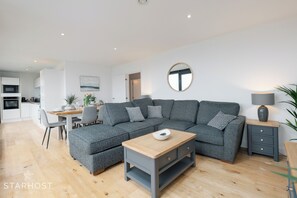 The living room is bright and spacious and offers a relaxing atmosphere