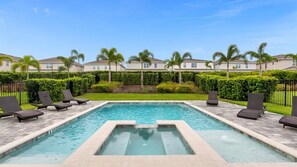 Dive into relaxation in your private oasis, complete with a spa and sun loungers, surrounded by lush greenery.