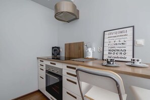 Kitchenette with oven and dining area. 