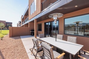 Back Patio Seating and Grill - The Back Patio includes an outdoor dining table, BBQ grill, and sliding glass door that leads into the living room.