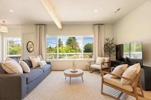 Enjoy a serene view of the lush greenery in the vacant lot across the street.