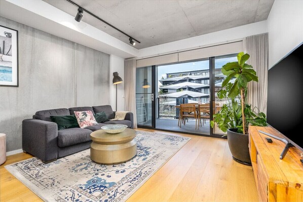 Step into the stylish lounge room, where modern elegance meets comfort. With its chic furnishings and sophisticated decor, this space offers a perfect blend of style and relaxation, making it an ideal spot for unwinding or entertaining guests.