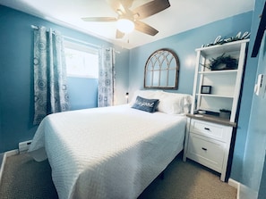 2nd bedroom with ceiling fan, under the bed storage, hooks and blackout shades.