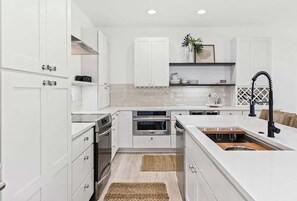 A chef's dream with top-of-the-line appliances and sleek counters.