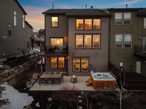 Private outdoor patio boasts a dining area for eight, a cozy fire pit, and a relaxing hot tub | Noah's Retreat, Park City, Utah | Voyax Luxury Vacation Rentals