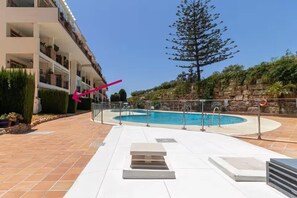 The arrow points to the apartment, right next to the swimming pool