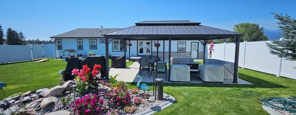 Backyard oasis with pondless waterfall 20x28 patio, gazebo, bluetooth speakers.