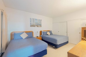 Spacious room with a queen & double bed, TV, dresser, and closet—perfect for families or friends to relax and feel right at home.