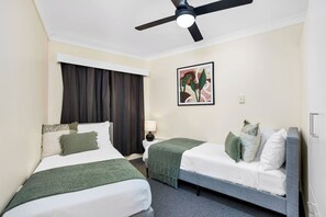 Bedroom 2 with two single-size beds, please note this bedroom doesn't have AC but it can be easily cooled down by AC in the living room and ceiling fan.
