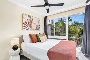 Bedroom 1 with a queen-size bed and a private balcony.