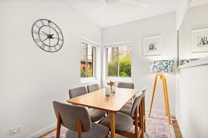Enjoy a meal together at a wooden six-seater table bathed in sunlight.