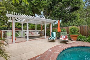 Relax by the pool under a covered patio