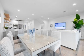Dining table with seating for six and three counter stools at the kitchen peninsula.