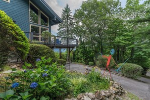 Quirky sculpture and beautiful landscaping surrounding the home.