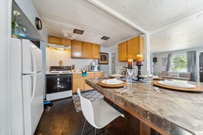 The kitchen is fully stocked with a stylish dining area.