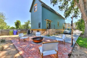 String lights & concrete cornhole. Patio bricks from original house foundation.