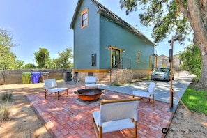 String lights & concrete cornhole. Patio bricks from original house foundation.