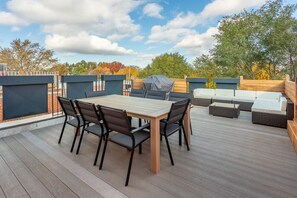 Spacious balcony with a dining table—ideal for enjoying meals with a view.