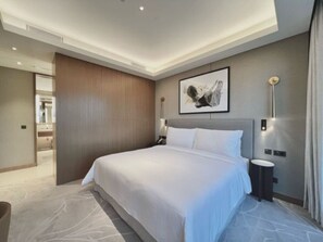 Elegant bedroom in a 3-bedroom holiday home in Dubai's Opera Tower 1, featuring a plush king-sized bed, sophisticated decor, and ambient lighting. Ideal for vacation rentals, short-term stays, or monthly accommodations in Downtown Dubai.