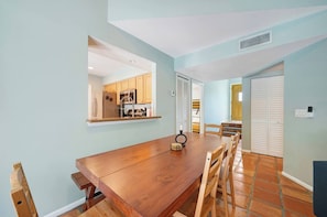The dining area features a spacious 6-seater table, perfect for enjoying meals with family and friends.